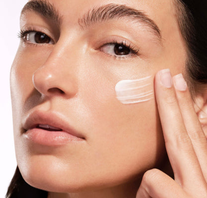Woman applying Symphonic M.D. to face