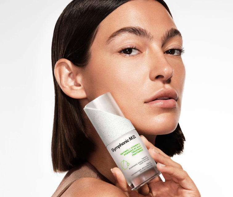 Woman holding Symphonic M.D. Retinol Vitamin C Treatment